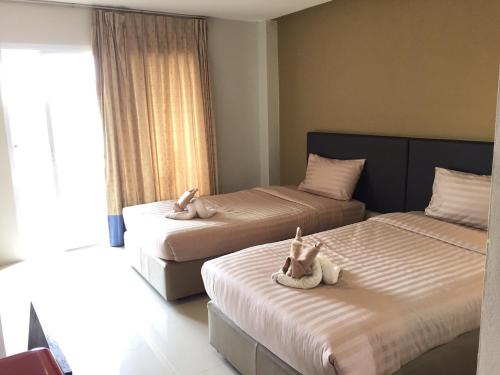 Postel nebo postele na pokoji v ubytování Silom Boutique Hotel Hatyai