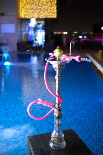 a glass dish with a ball on it next to a pool at Best Western Plus Pearl Creek in Dubai
