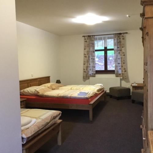 a bedroom with two beds and a window at Relax pension Schonwald in Budišov nad Budišovkou