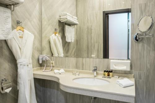 a bathroom with a sink and a mirror at Marlin in Odesa