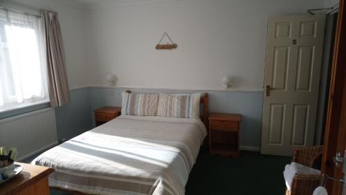 Ένα ή περισσότερα κρεβάτια σε δωμάτιο στο Harbourlight Guesthouse
