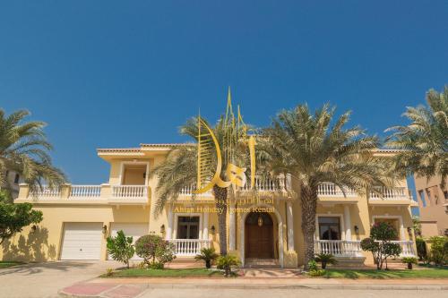 a large house with palm trees in front of it at SEA and ATLANTIS VIEW BEACHFRONT PALATIAL 4 BR VILLA PRIVATE SAUNA POOL BEACH PALM JUMEIRAH in Dubai