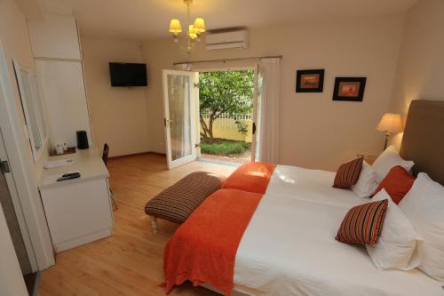 Ένα ή περισσότερα κρεβάτια σε δωμάτιο στο Villa Moringa Guesthouse