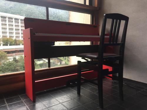 a chair sitting in front of a window at kinugawaonsen Fukumatsu in Nikko
