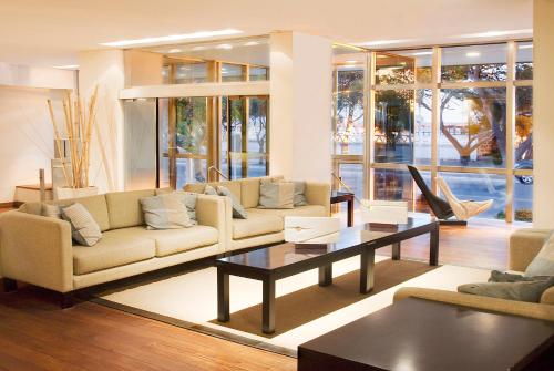 a living room with couches and a coffee table at Hotel Península Valdés in Puerto Madryn