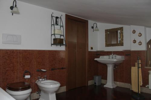 a bathroom with a toilet and a sink at Paoline's suite in villa in Fiumicino