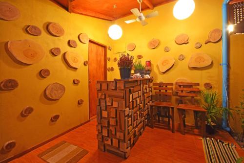 a room with a wall filled with wooden logs at Beach Villa Ukulhas in Ukulhas
