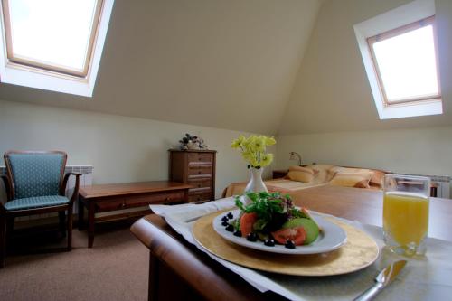 a plate of food on a table in a room at Resort Jura in Kroczyce