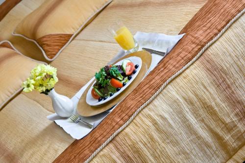 a plate of food on a table with a glass of orange juice at Resort Jura in Kroczyce