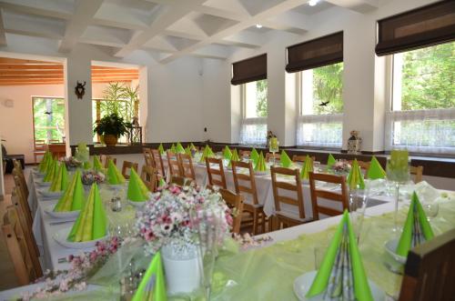 a banquet hall with tables and chairs with green napkins at Chata Patúch in Babkov