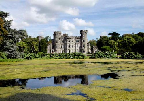 a castle with a pond in front of it at Faythe Holiday Home Wexford Town in Wexford