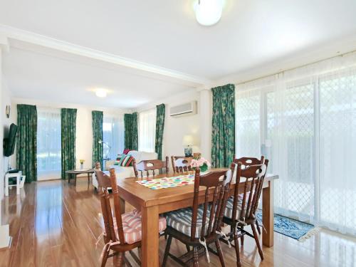 a dining room with a table and chairs at Moana Magic - C21 SouthCoast Holidays in Moana