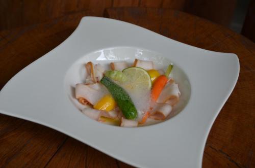 a bowl of soup with vegetables in it on a table at Chata Patúch in Babkov