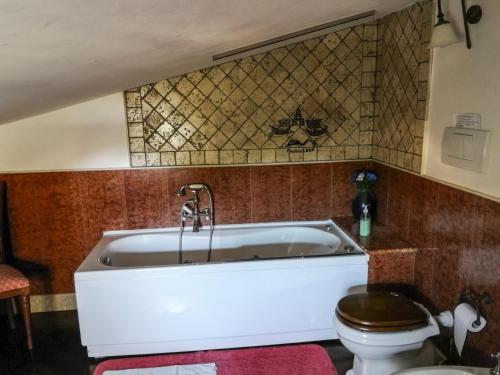 a bathroom with a bath tub and a toilet at Paoline's suite in villa in Fiumicino