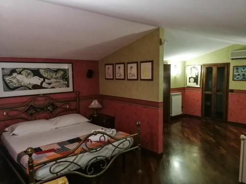 a bedroom with a bed with red walls at Paoline's suite in villa in Fiumicino