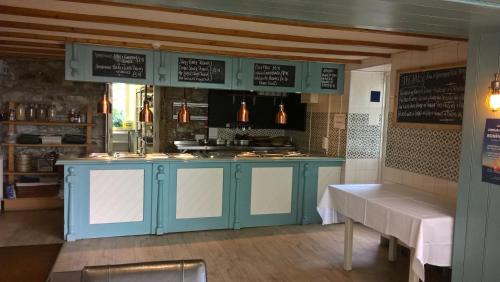 a kitchen with a blue island in a kitchen at The Badger Inn in Carbis Bay