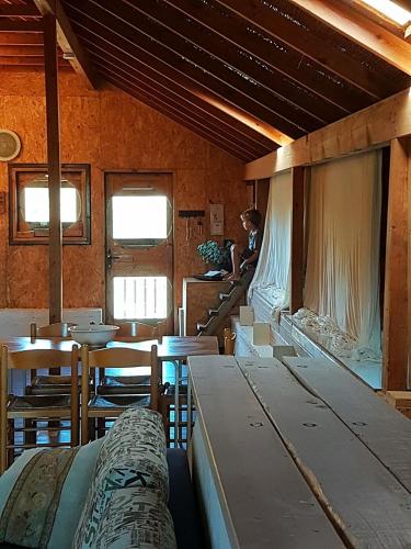 a room with tables and chairs in a train car at Healing Hands in Merom Golan