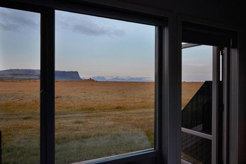 a window with a view of the desert outside at Fosshotel Nupar in Kálfafell