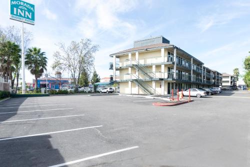 an empty parking lot in front of a building at Morada Inn in Anaheim