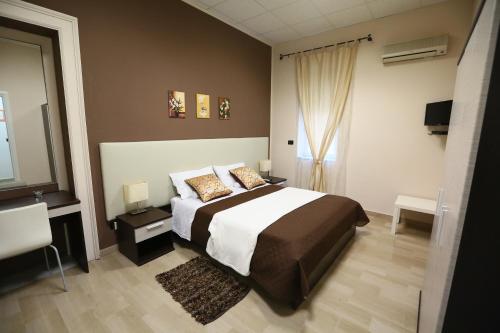 a bedroom with a large bed and a window at Civico7 in Villa San Giovanni