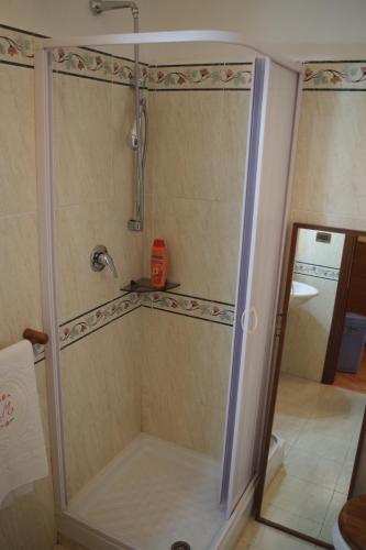 a shower with a glass door in a bathroom at MaMaViHouse in Rome