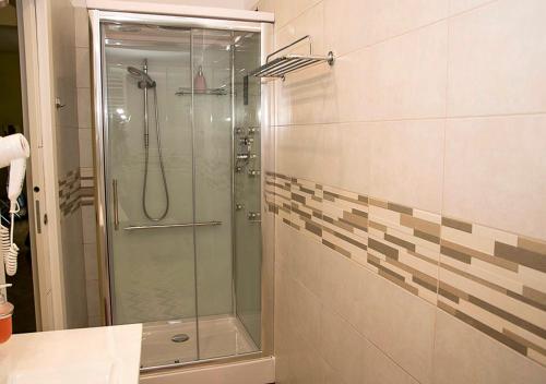 a shower with a glass door in a bathroom at B&B Borfuro in Bergamo