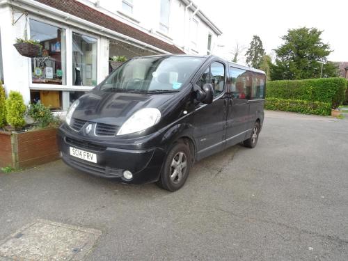 a black van parked in front of a house at The Gatwick White House Hotel in Horley