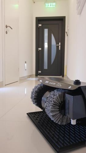 a computer keyboard laying on the floor in front of a door at Studio-Apartment VAL - Luxury massage chair - Private SPA- Hot Tub, Infrared Sauna, , Parking with video surveillance, Entry with PIN 0 - 24h, FREE CANCELLATION 24 hours before Check In, Premium pillows and mattress in Slavonski Brod