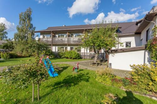 a house with a yard with a slide at Endla Hotell in Viljandi