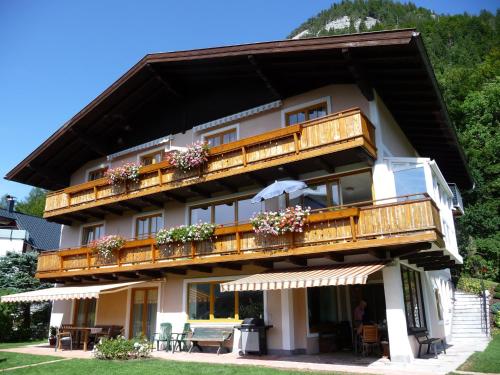 a building with wooden balconies and flowers on it at Haus Lungau in Fuschl am See