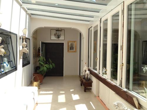 a hallway with large windows and a ceiling at Domus Felix in Sorrento