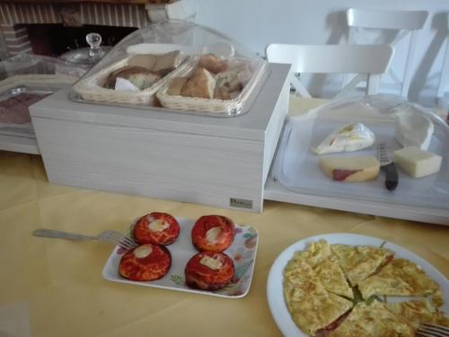 a table with two boxes of food and a plate of food at B&B Il Belvedere in Guardialfiera
