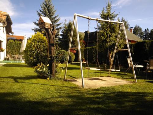 an empty swing set in a yard at Villa Bozovic in Zlatibor