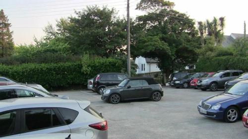 a bunch of cars parked in a parking lot at The Badger Inn in Carbis Bay