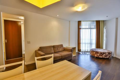 a living room with a couch and a table at Hotel Orizzonte Niteroi by Atlantica in Niterói