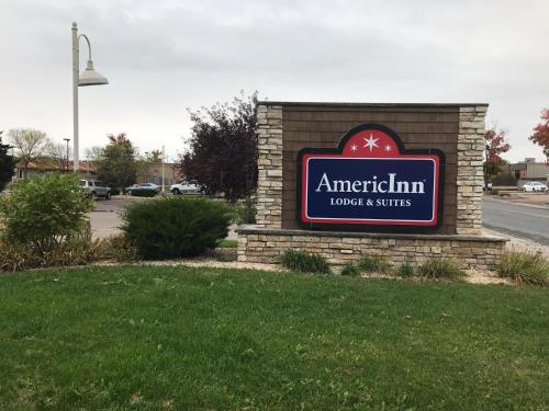 a sign for the american sign hotel as strings at AmericInn by Wyndham Hotel and Suites Long Lake in Long Lake