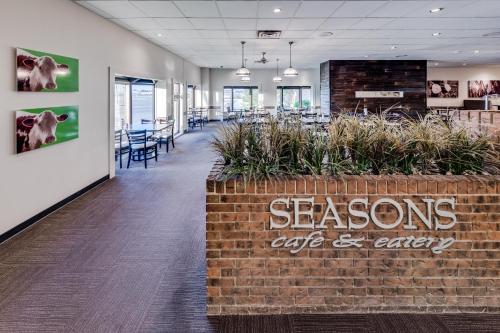 an office with a brick wall with a sign that reads seasons egg and array at Heritage Inn Hotel & Convention Centre - Taber in Taber