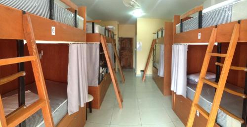 a room with several bunk beds in a dorm room at Jomtien Hostel in Jomtien Beach