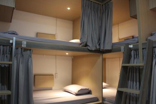 a group of bunk beds in a room at Usagiyah Hotel & Guest House in Ho Chi Minh City