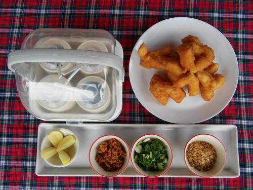 a lunch box with food on a table at Saengcha Farm Resort in Prachin Buri