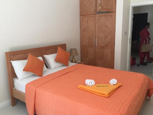 a bedroom with a bed with two towels on it at West Front One No 4 with SEAFRONT - LICENSED BY TOURISM AUTHORITY 14977 Flic en Flac Mauritius in Flic-en-Flac