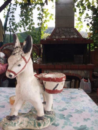 a statue of a dog standing on a table at Roula Rooms in Stratónion