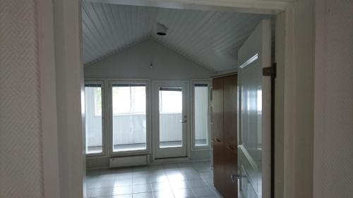 an empty room with windows and a ceiling at Talvitaival Apartments in Varkaus