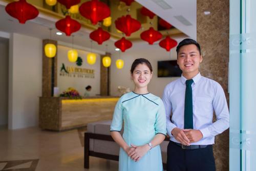 a man and a woman standing next to each other at Ally Beach Boutique Hotel Hoian in Hoi An
