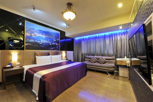 a hotel room with a bed and a couch at ZJ Motel in Hsinchu City