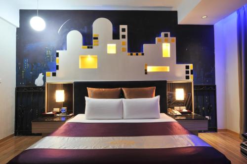 a bedroom with a large bed with lights on it at ZJ Motel in Hsinchu City