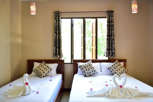 Ένα ή περισσότερα κρεβάτια σε δωμάτιο στο Siam Guesthouse