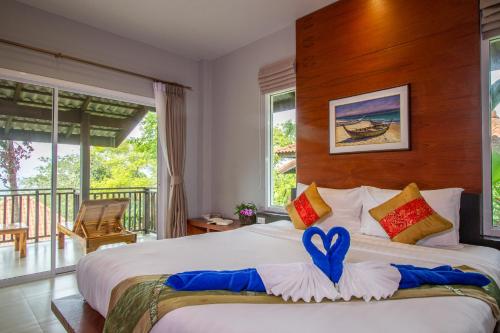 a bedroom with a large bed with a heart on it at Bakantiang Resort in Ko Lanta