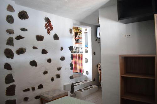 una habitación con una pared con rocas. en CASA RURAL Vv SATORNO, en Tinguatón