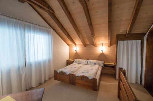 a small bedroom with a bed and a window at Hotel Bahnhof in Giswil